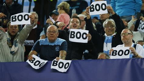 Manchester City fans hold up 'boo' signs before Champions League game ...