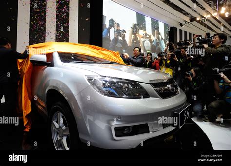 Wang Chuanfu, chairman of BYD, poses next a BYD S6 at the Beijing Auto ...