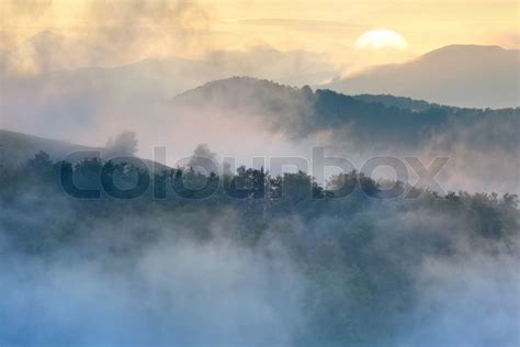 Beautiful foggy sunrise in the mountains | Stock image | Colourbox