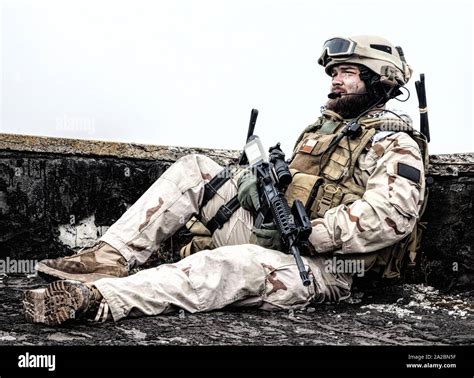 U. S. Navy SEAL infantryman, commando marksman in battle uniform, armed ...