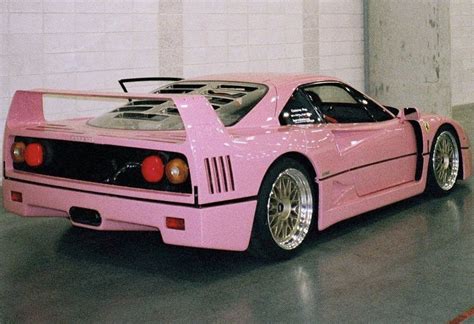 a pink sports car parked in a garage