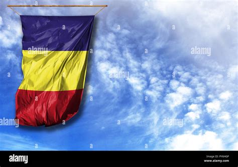 Flag of Romania. Vertical flag, against blue sky with place for your ...