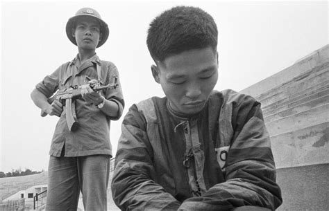 A Vietnamese soldier holds a Chinese prisoner at gunpoint during the ...