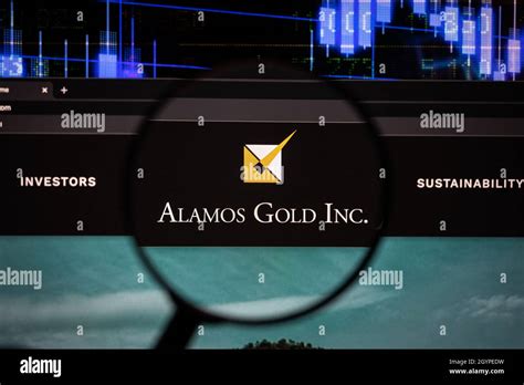 Alamos Gold Inc. company logo on a website with blurry stock market ...