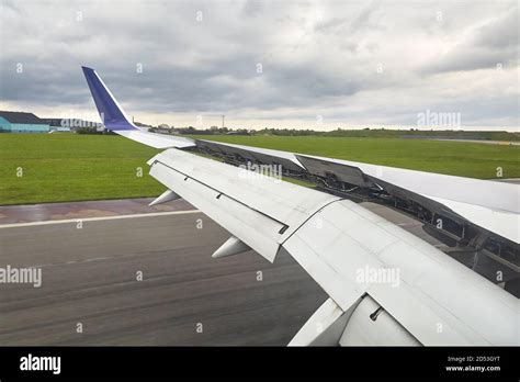 Landing plane wing flaps and spoilers extended Stock Photo - Alamy