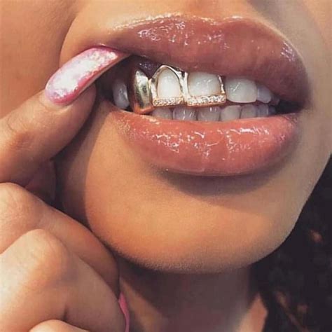 3 teeth grillz, 2 open face with cz/diamond stones. This is making a ...