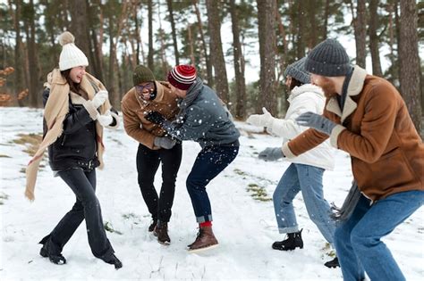 Premium Photo | Full shot people having fun with snow