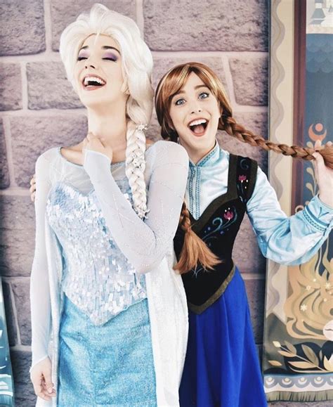 two women dressed as frozen princesses standing next to each other