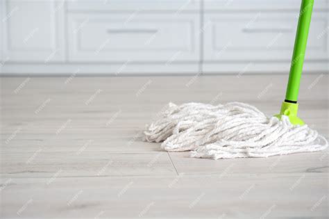 Premium Photo | Mopping of floor in kitchen