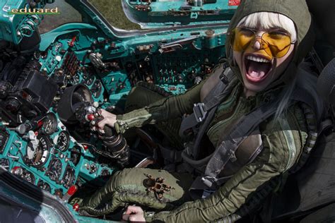 a woman with her mouth open sitting in the cockpit of a plane and ...