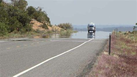 Mirage appearing as a layer of shimmering water on a hot road. - Stock ...