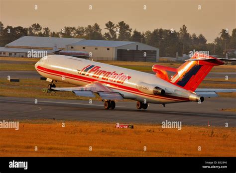 Boeing 727 courier jet landing at Victoria airport in early morning ...