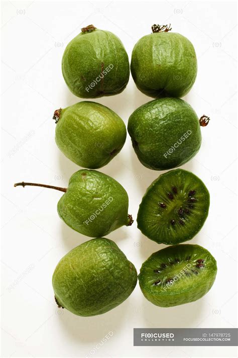 Mini-kiwi fruits whole and halved — diet, nutrition - Stock Photo ...