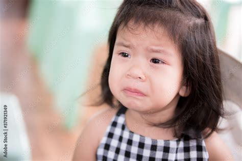 Close Up portrait of upset Asian adorable little girl. Cute child is ...