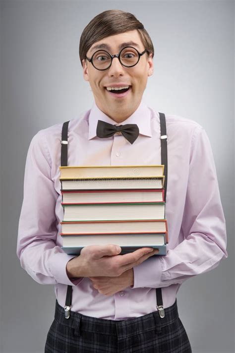 Nerd With Book Stack. Young Nerd Man Holding A Book Stack While Stock ...