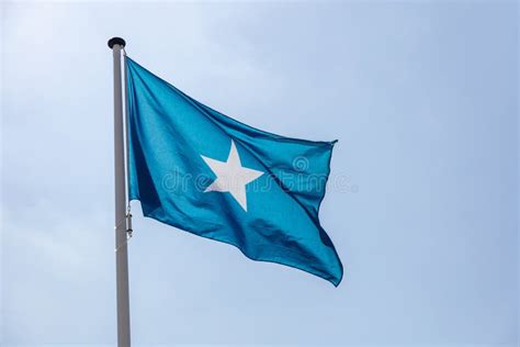 Somalia Flag Waving Against Clear Blue Sky Stock Image - Image of ...