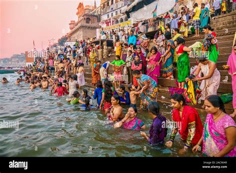 Colorful traditional clothing and Hindu religious ritual of bathing in ...