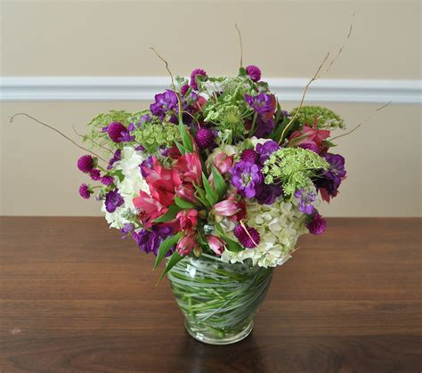 "Welcome back" floral arrangement with the accent of purple stock and ...