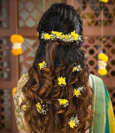 Photo of An open hairstyle with baby's breath and small yellow flowers