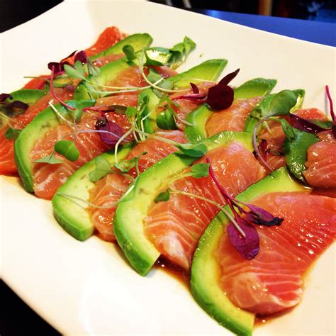 Crudo - salmon and avocado over ponzu sauce and garnished with micro ...