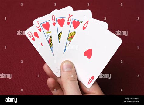 A royal flush poker hand cards fanned out and held in someones hand ...