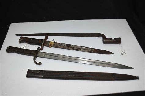 Three vintage rifle bayonets, one with scabbard