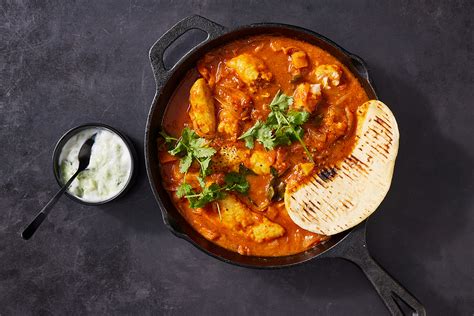 Mild hake curry with flatbreads and raita | Woolworths TASTE