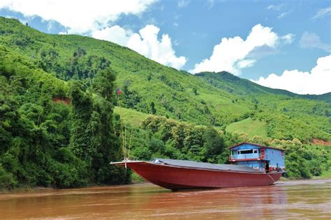 Large slow boat on Mekong River, Laos - Jetsetting Fools