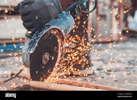 Construction worker using Angle Grinder cutting Metal at construction ...