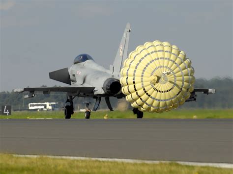 A_Typhoon_F2_fighter_jet_deploys_a_brake_parachute_as_it_lands_at_RAF ...