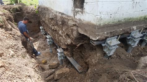 Foundation Repair - Sinking Foundation Supported with Helical Piers in ...