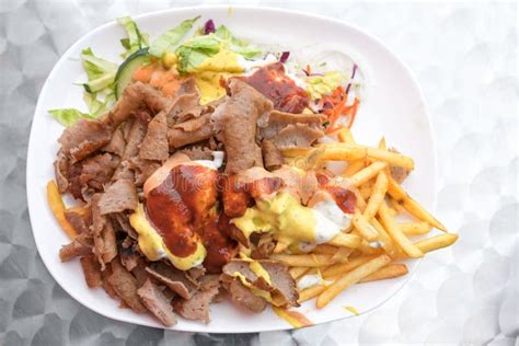 Doner Kebab on a Plate with French Fries, Salad and Various Sauces ...