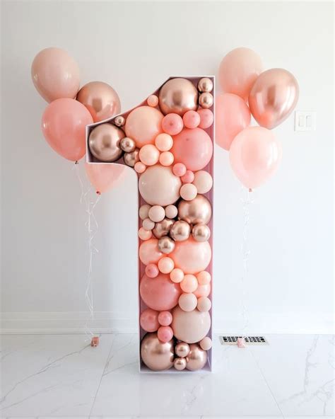 a number one made out of balloons in the shape of a balloon with pinks ...