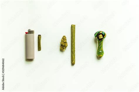 Simple marijuana flat lay. Marijuana flower, blunt, packed smoking bowl ...