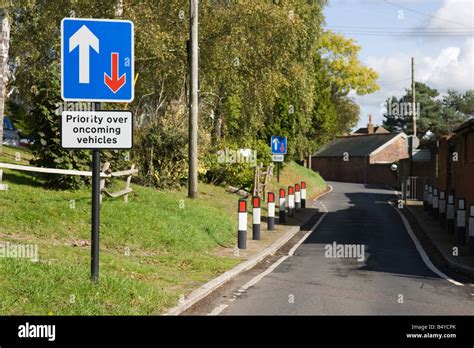 Single carriageway narrow road with sign that says priority over ...