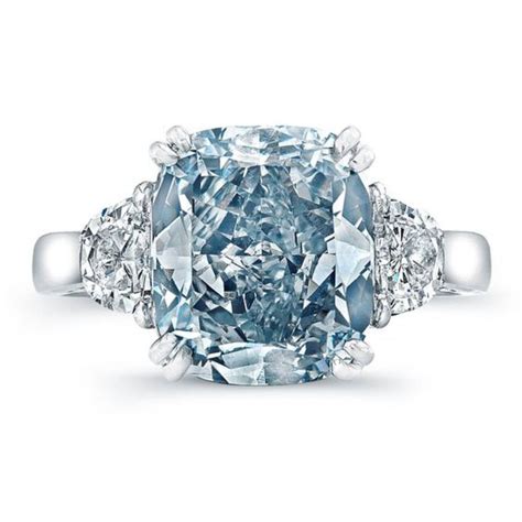 ice-blue diamond encircled by white diamonds and set off by a simple ...