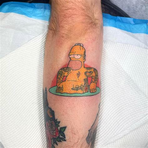 Homer Simpson tattoo located on the forearm.