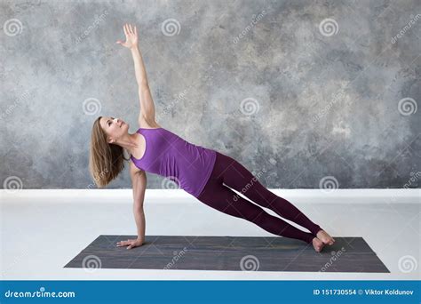 Slim Caucasian Woman Doing Side Plank Yoga Pose in Fitness Studio Stock ...