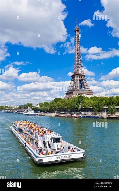 Bateaux Mouches tour boat on River Seine passing the Eiffel Tower ...