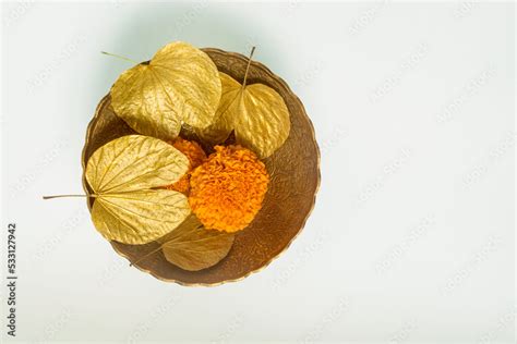 Symbolic golden leaves with marigold flowers in the bowl for the ...