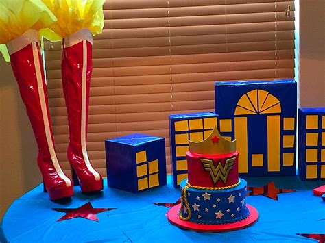 a table topped with a cake and tall boots