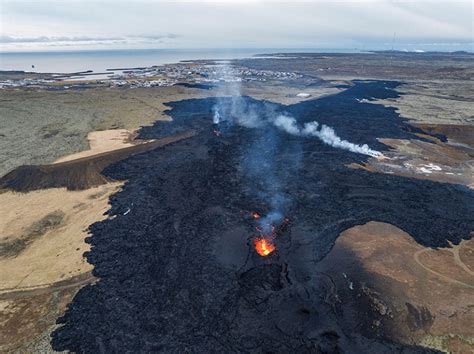 In pictures: lava flows into Icelandic town during volcanic eruption