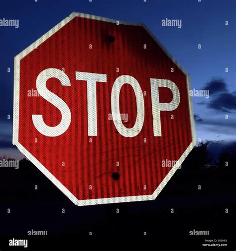 Stop sign at night Stock Photo - Alamy