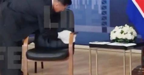 Bizarre moment Kim Jong-un's bodyguards sweeps his chair before meeting ...