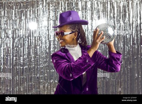 Happy black woman in costume hold disco ball Stock Photo - Alamy