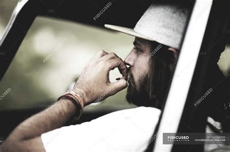 Bearded man wearing baseball cap — car window, hat - Stock Photo ...