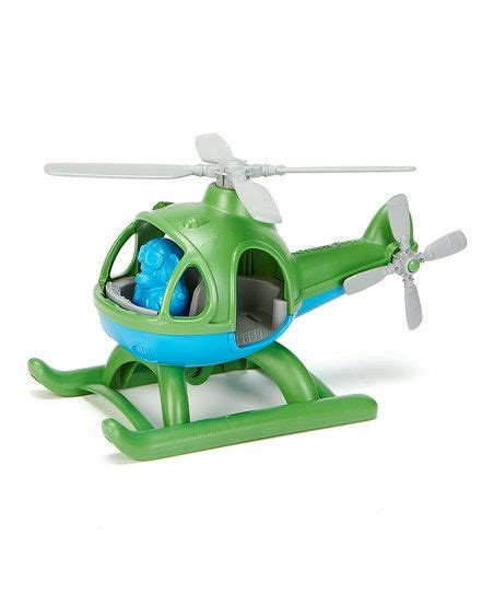 a green toy helicopter sitting on top of a white surface