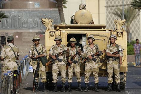 Egyptian Army soldiers take their positions near an M113 APC to guard ...