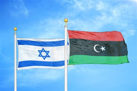 Israel And Libya Two Flags On Flagpoles And Blue Cloudy Sky Stock Photo ...