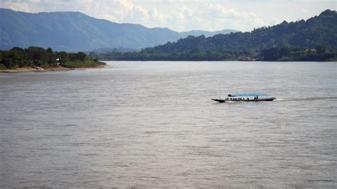 slow boat cruising along the Mekong River, Local boat moving on Mekong ...